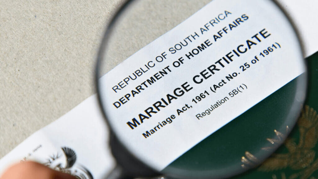 Marriage certificate checking closely with passport 