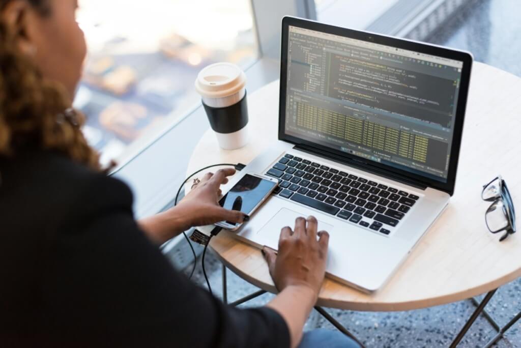 a girl sitting in the cafe doing coding