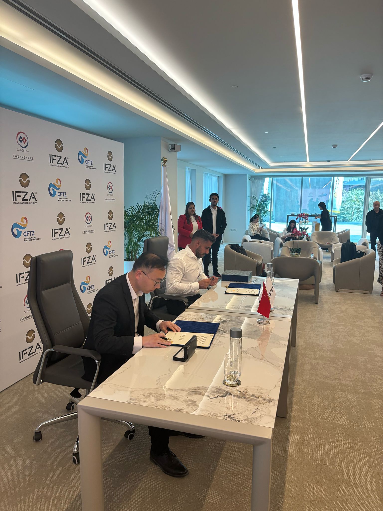 Signing ceremony at IFZA free zone event